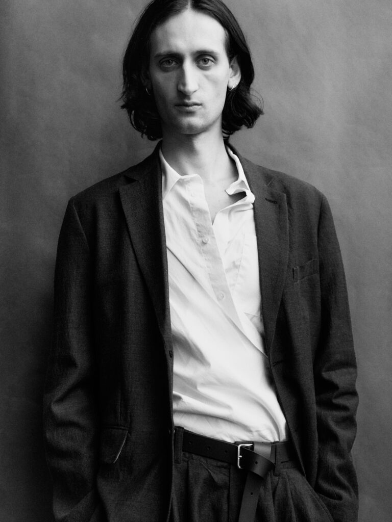 ARTELIER AW26 campaign: male model in dark tailoring and a white shirt